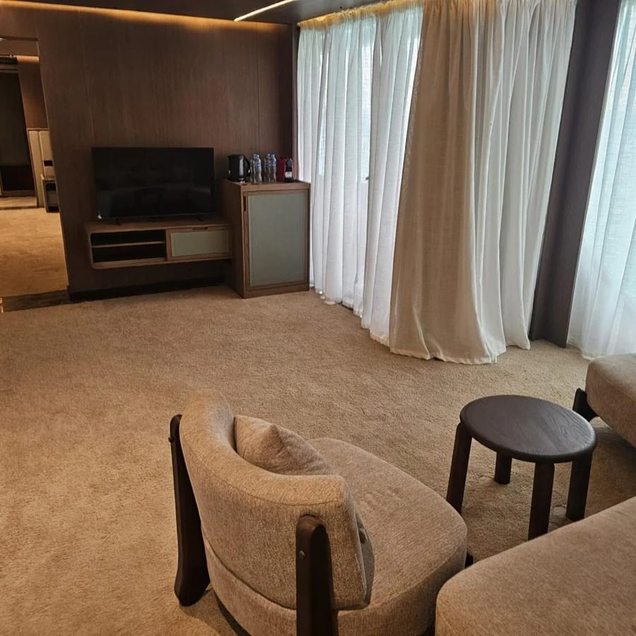 The yacht's interior features a cozy seating area with a television and soft lighting. aboard JASMINE Yacht for Sale