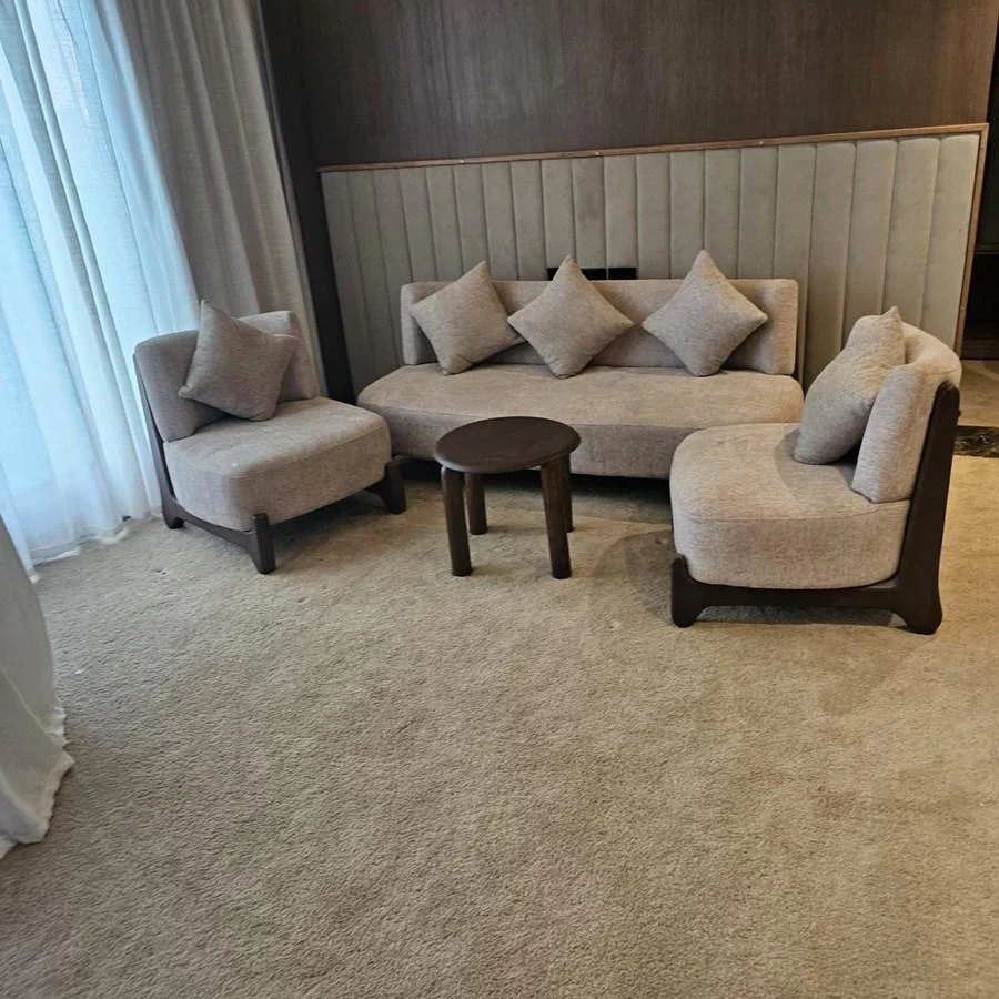 A cozy seating area with plush beige furniture and a small round table. aboard JASMINE Yacht for Sale
