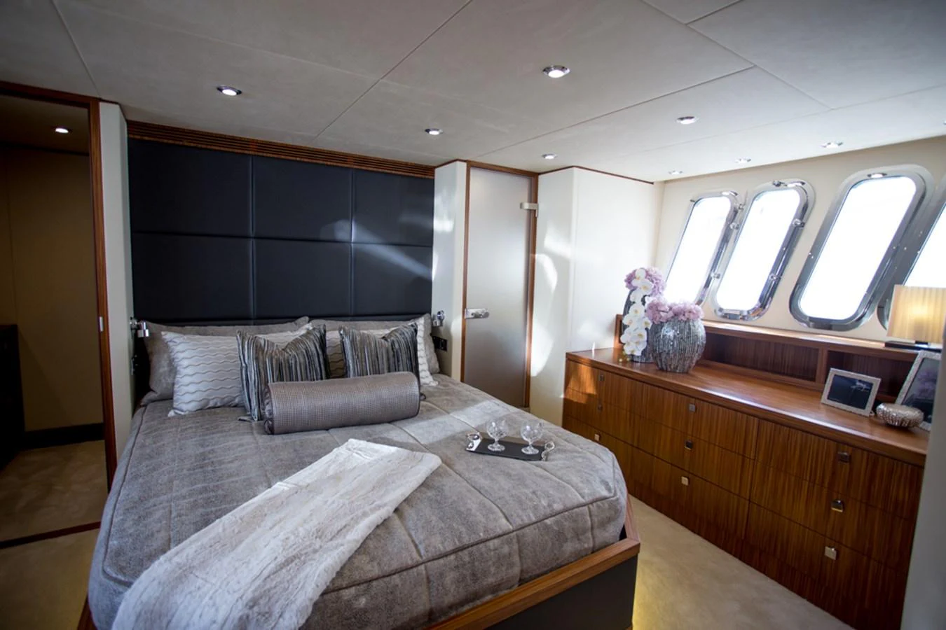 The stateroom features a plush bed, elegant decor, and ample natural light from the windows. aboard MAZARIN 72 FLYBRIDGE Yacht for Sale