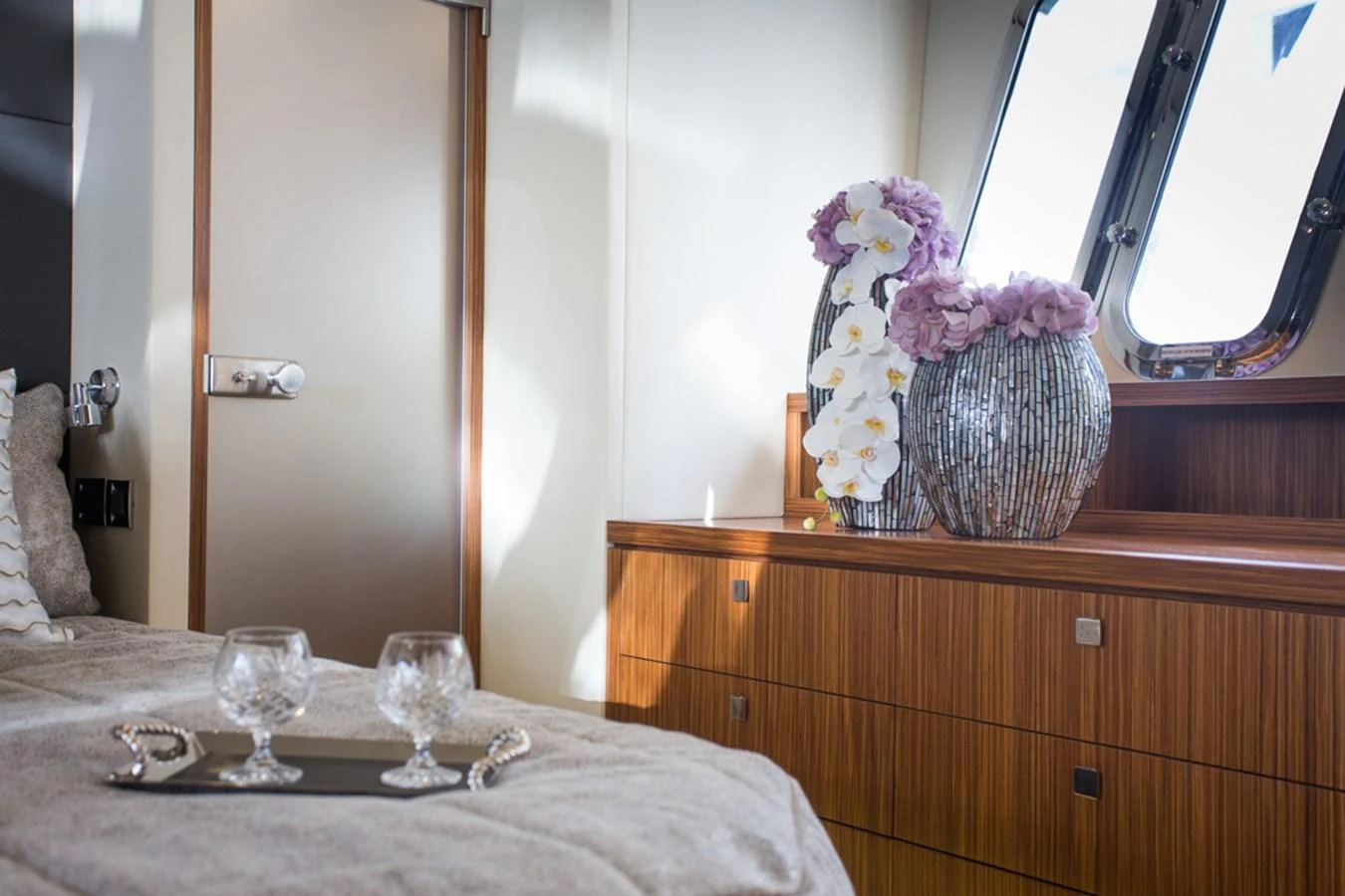 The stateroom features elegant decor with a touch of luxury, highlighted by fresh flowers and natural light. aboard MAZARIN 72 FLYBRIDGE Yacht for Sale