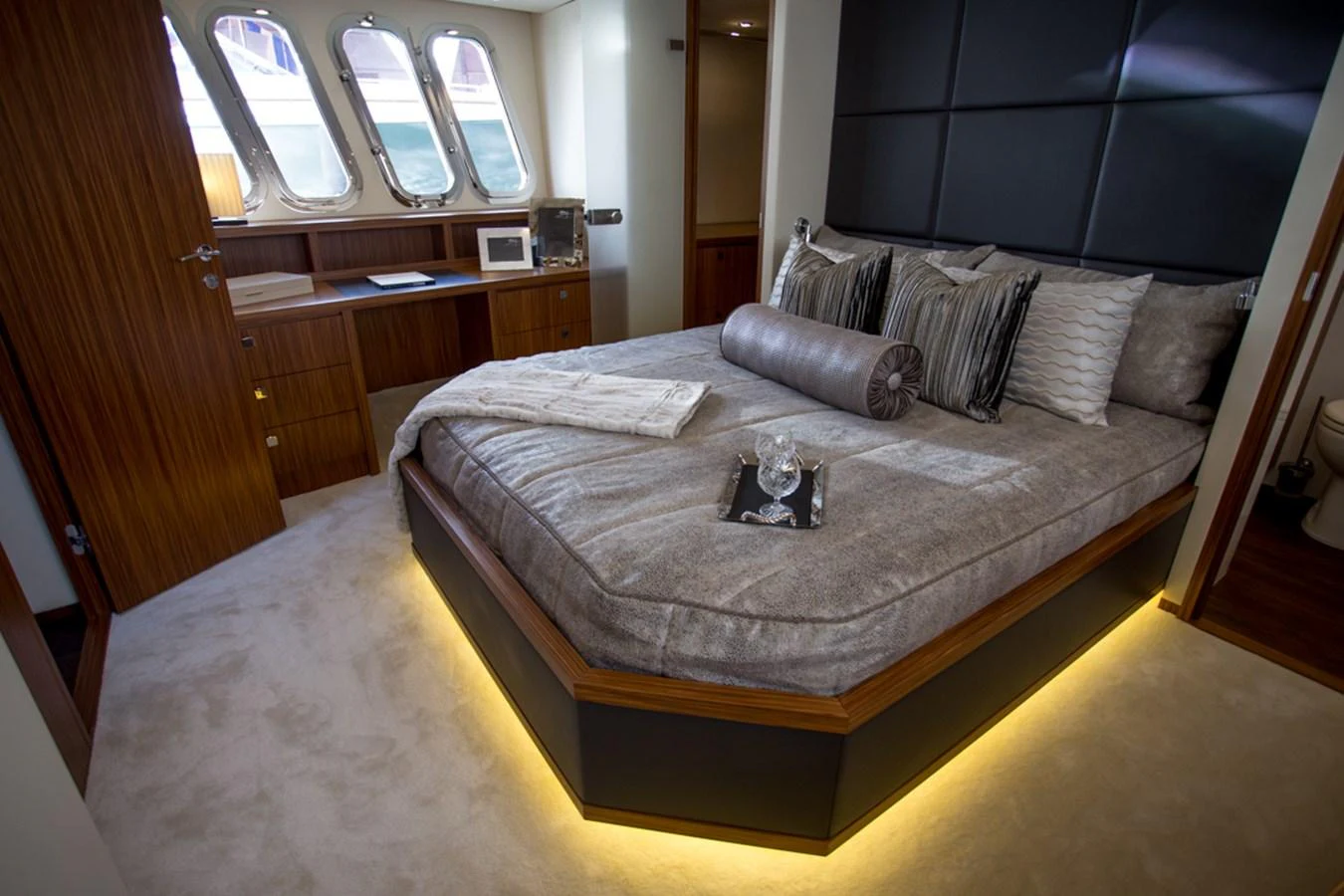 The stateroom features a luxurious bed with elegant bedding and ambient lighting, creating a cozy and inviting atmosphere. aboard MAZARIN 72 FLYBRIDGE Yacht for Sale