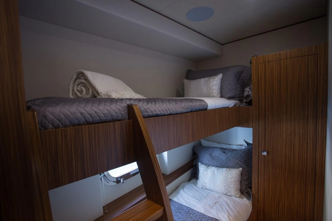 The cozy bunk cabin features neatly arranged beds with plush bedding, creating a comfortable retreat. aboard MAZARIN 72 FLYBRIDGE Yacht for Sale