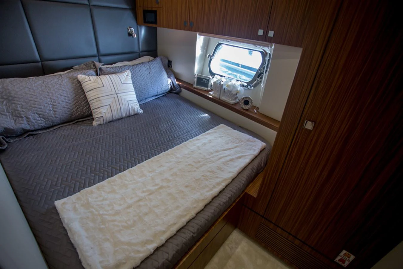 A cozy stateroom featuring a comfortable bed and a window providing natural light. aboard MAZARIN 72 FLYBRIDGE Yacht for Sale