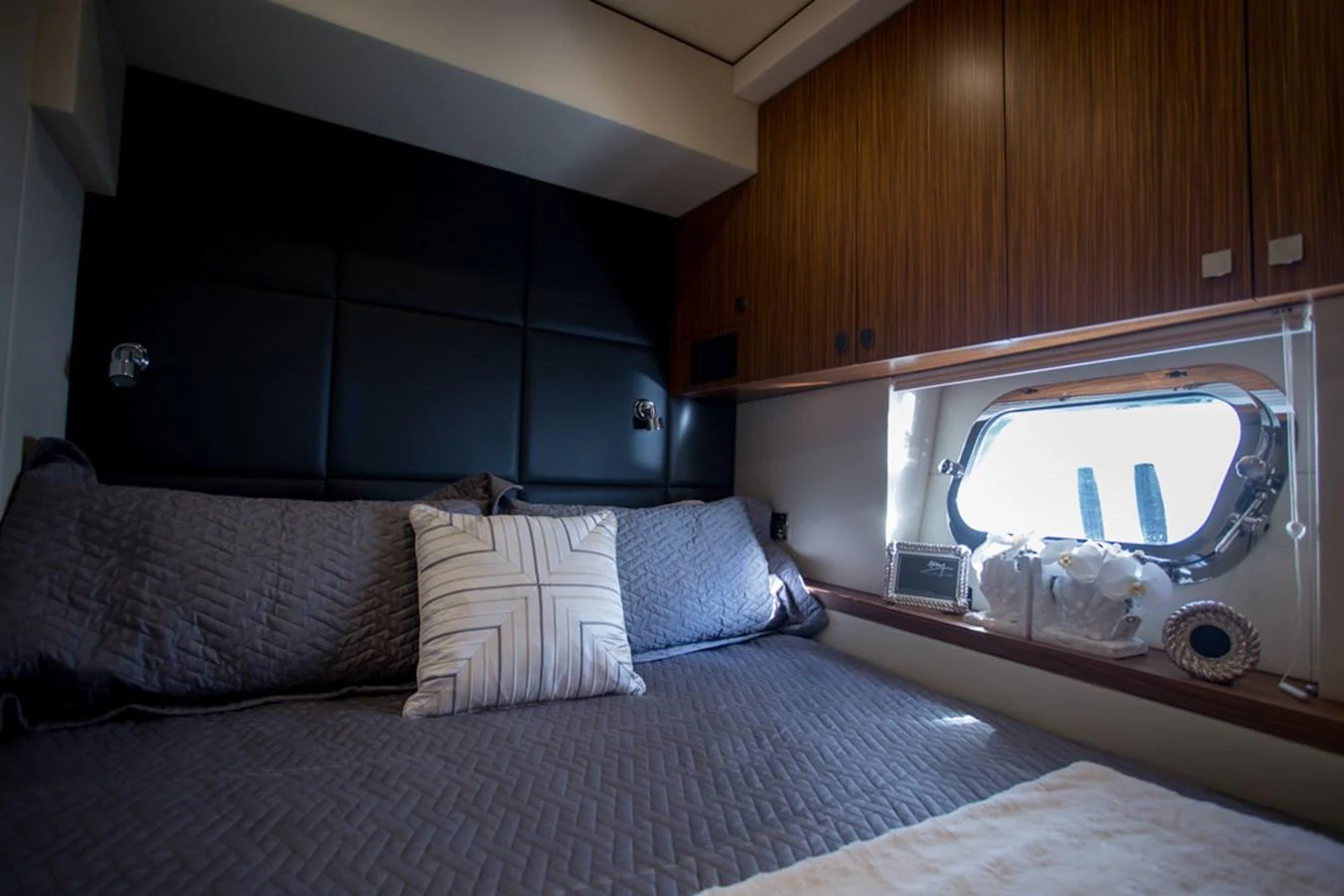 A cozy stateroom with a large bed and a window providing natural light. aboard MAZARIN 72 FLYBRIDGE Yacht for Sale