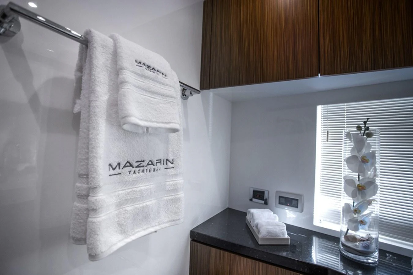 A sleek and modern yacht bathroom featuring luxurious towels and elegant decor. aboard MAZARIN 72 FLYBRIDGE Yacht for Sale