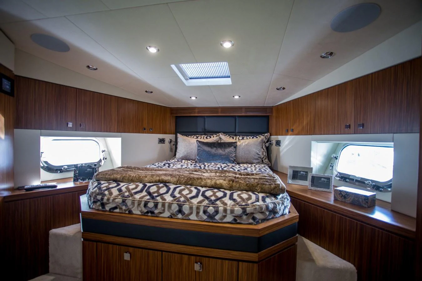 The master stateroom features a luxurious bed with elegant bedding and ample natural light from side windows. aboard MAZARIN 72 FLYBRIDGE Yacht for Sale