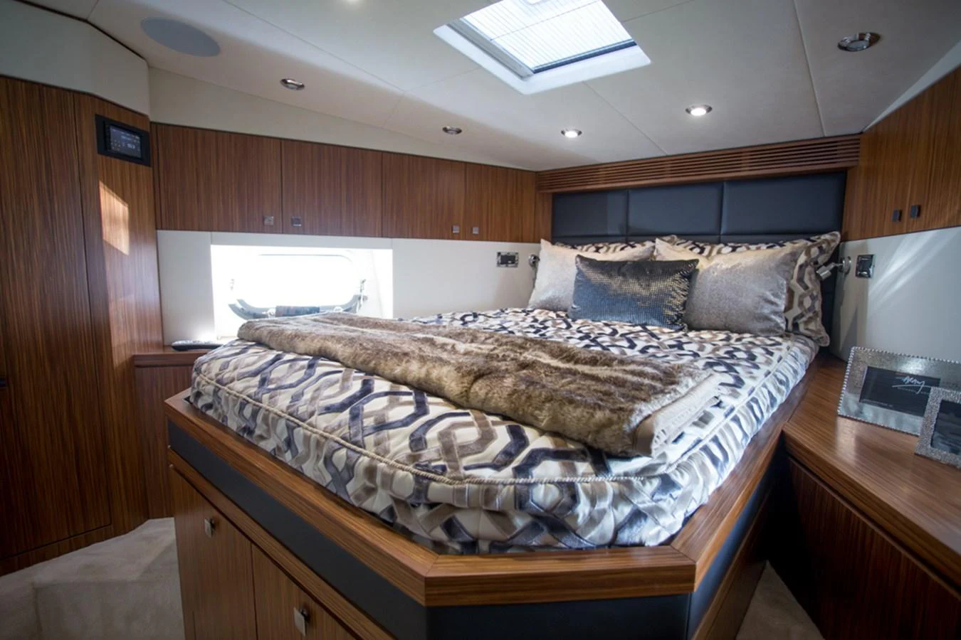 The stateroom features a luxurious bed with elegant bedding and ample natural light from a skylight. aboard MAZARIN 72 FLYBRIDGE Yacht for Sale