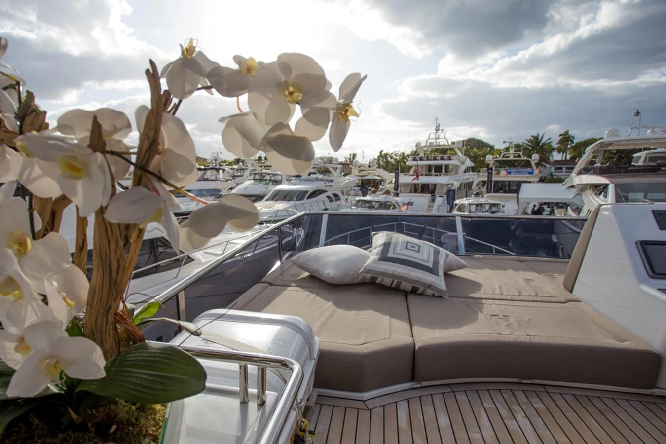 The sundeck offers a luxurious lounging area with plush cushions and elegant floral arrangements, perfect for relaxation. aboard MAZARIN 72 FLYBRIDGE Yacht for Sale