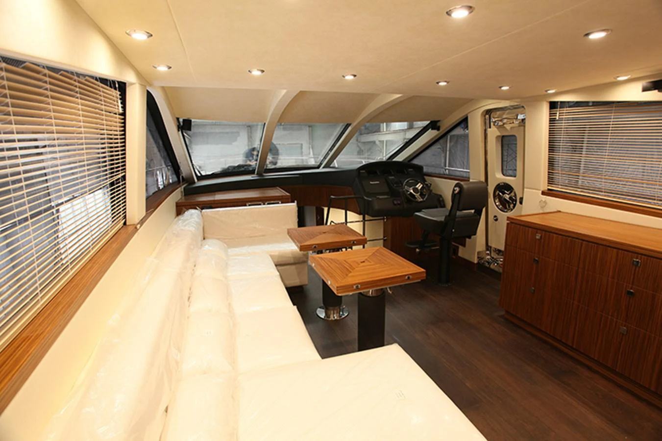 The helm area features a sleek control station with adjacent seating and large windows for optimal visibility. aboard MAZARIN 72 FLYBRIDGE Yacht for Sale