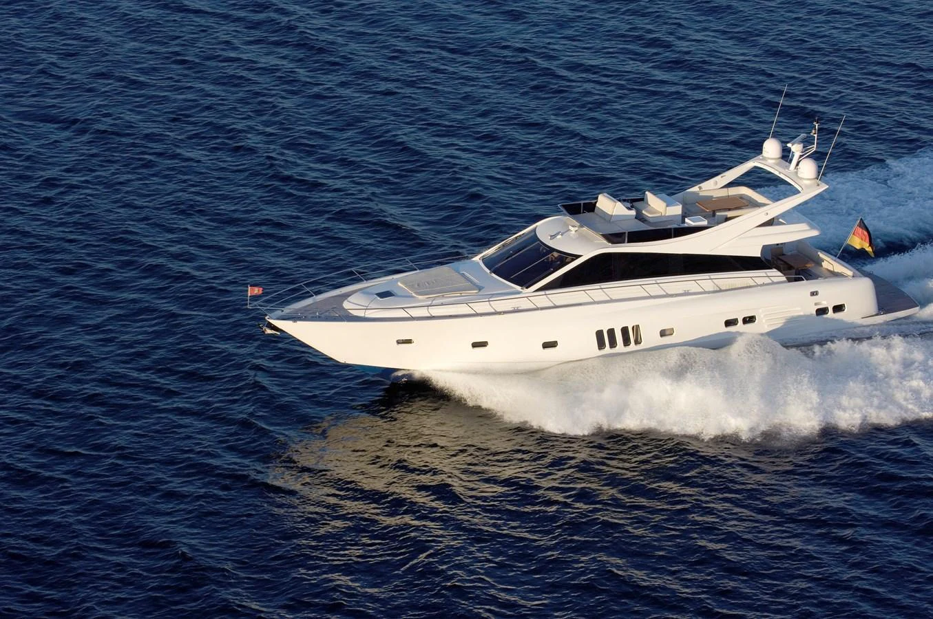 A sleek, modern yacht cruises swiftly over the open water, showcasing its elegant design and powerful performance. aboard MAZARIN 72 FLYBRIDGE Yacht for Sale