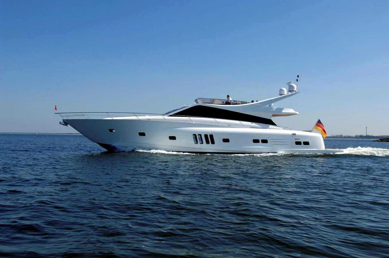 A sleek and modern yacht glides effortlessly through calm waters under a clear blue sky. aboard MAZARIN 72 FLYBRIDGE Yacht for Sale