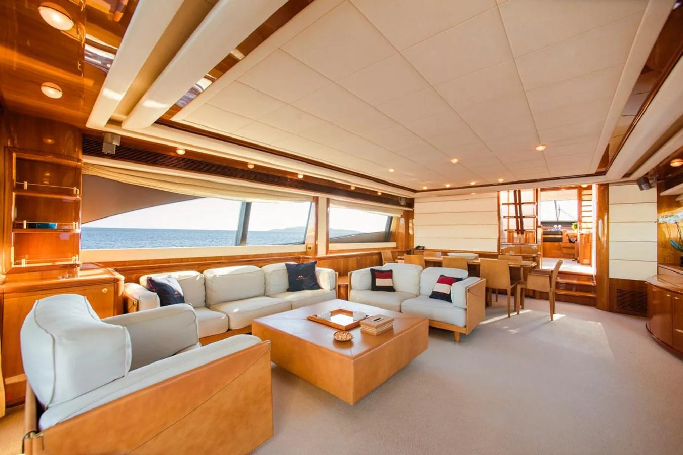 The yacht's salon features luxurious seating with panoramic ocean views. aboard FERRETTI 881 Yacht for Sale