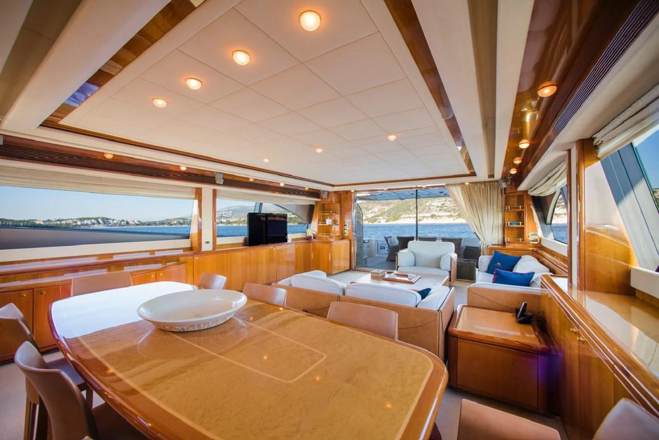 The spacious salon features luxurious seating and panoramic windows offering stunning views. aboard FERRETTI 881 Yacht for Sale