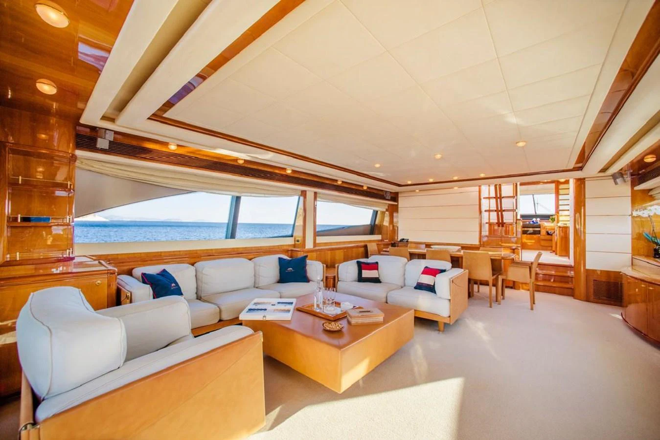 The yacht's salon features luxurious seating with panoramic ocean views. aboard FERRETTI 881 Yacht for Sale