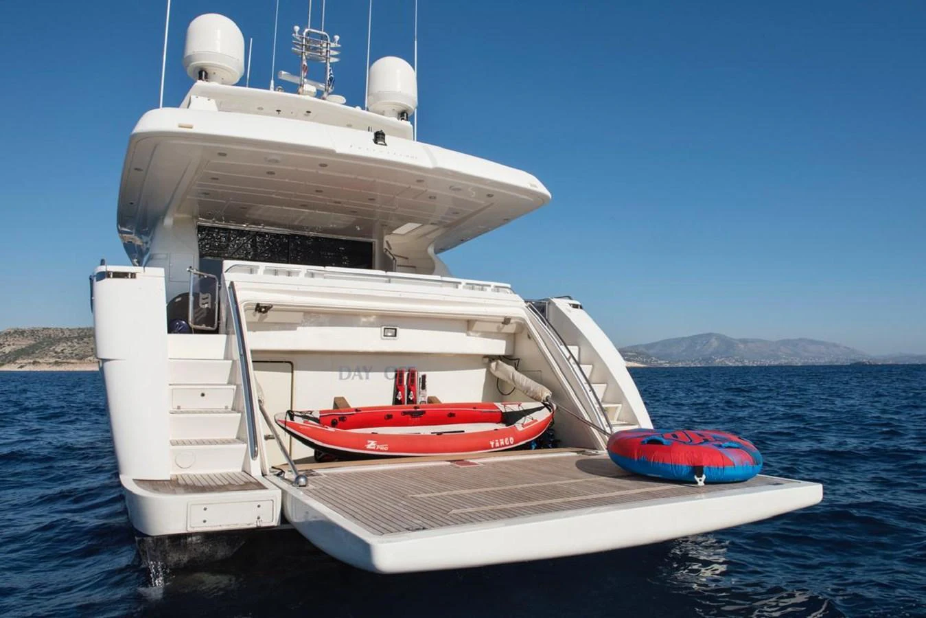 The aft deck of the yacht features a tender and an inflatable toy, ready for water activities. aboard FERRETTI 881 Yacht for Sale