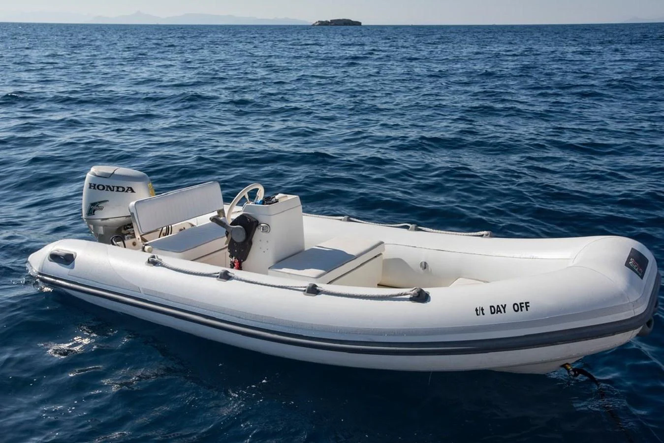 A sleek white tender floats on calm blue waters, ready for quick trips to shore. aboard FERRETTI 881 Yacht for Sale