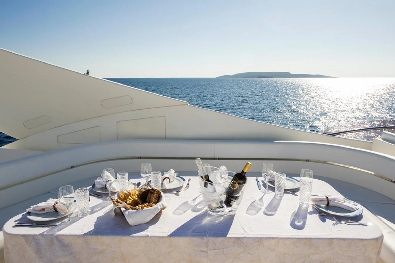 An elegant dining setup on the aft deck offers a picturesque ocean view. aboard FERRETTI 881 Yacht for Sale