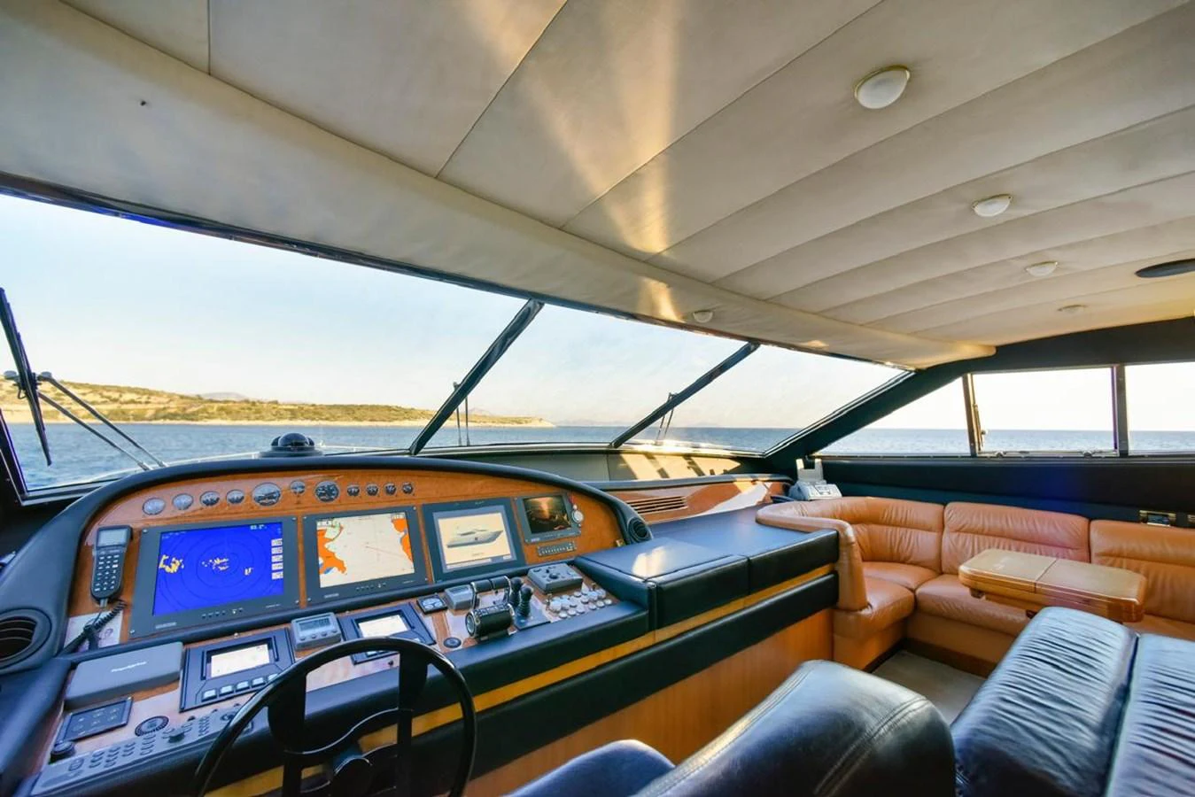 The helm station features advanced navigation equipment and a comfortable seating area with panoramic views. aboard FERRETTI 881 Yacht for Sale