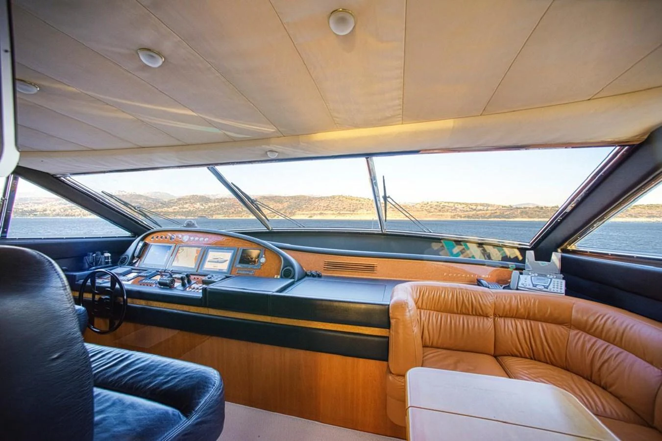 The helm of the yacht offers a panoramic view with luxurious seating and advanced navigation equipment. aboard FERRETTI 881 Yacht for Sale