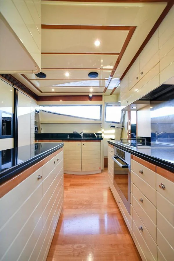 The yacht's galley features modern appliances and ample storage in a sleek, well-lit space. aboard FERRETTI 881 Yacht for Sale