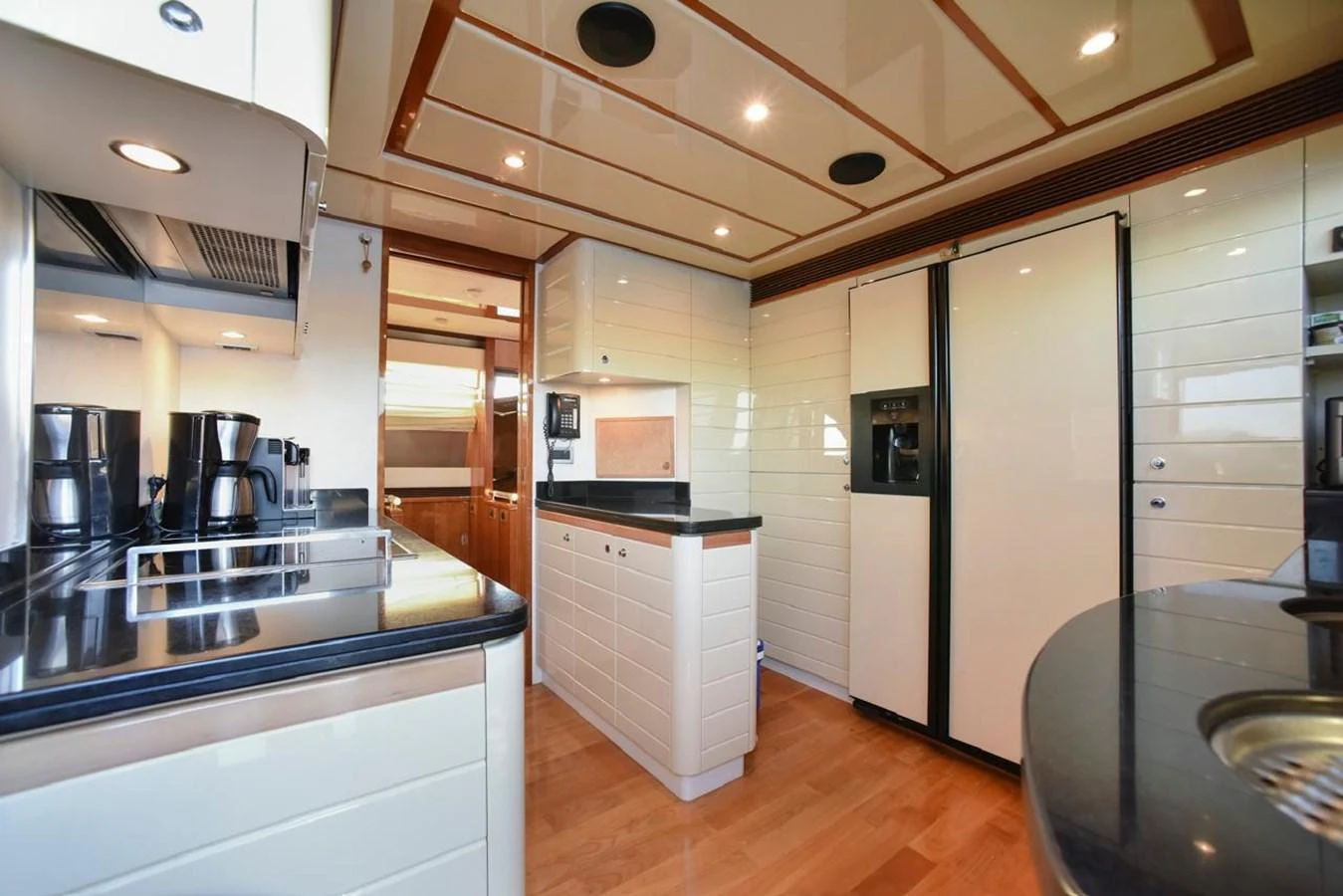 The yacht's galley is equipped with modern appliances and ample counter space, perfect for gourmet meal preparation. aboard FERRETTI 881 Yacht for Sale