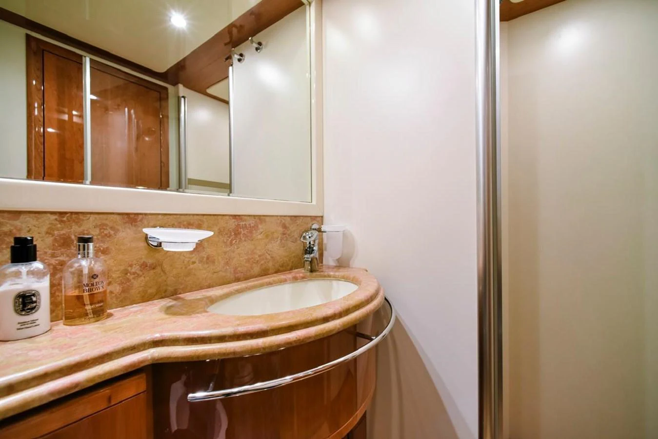 The yacht's bathroom features a sleek vanity with a polished countertop and modern fixtures. aboard FERRETTI 881 Yacht for Sale