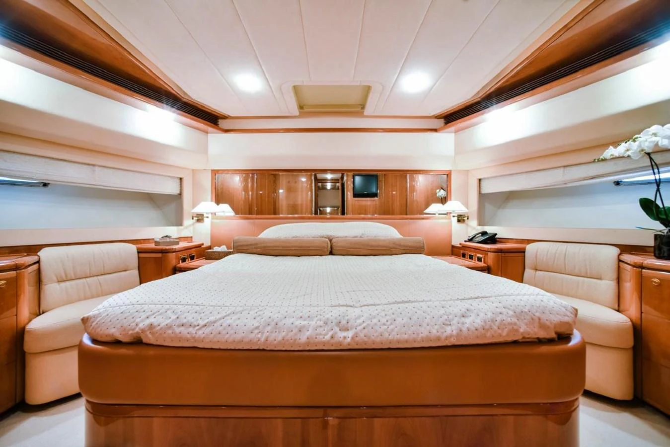 The master stateroom features a spacious and luxurious bed with elegant wood finishes and ample lighting. aboard FERRETTI 881 Yacht for Sale