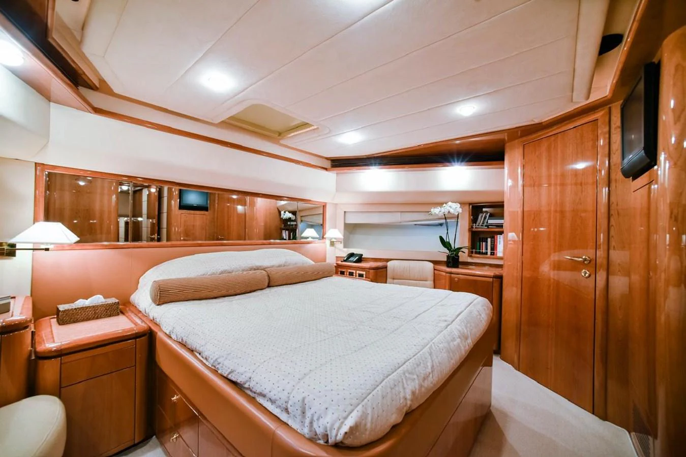 The master stateroom features a spacious bed, warm wood finishes, and elegant lighting. aboard FERRETTI 881 Yacht for Sale