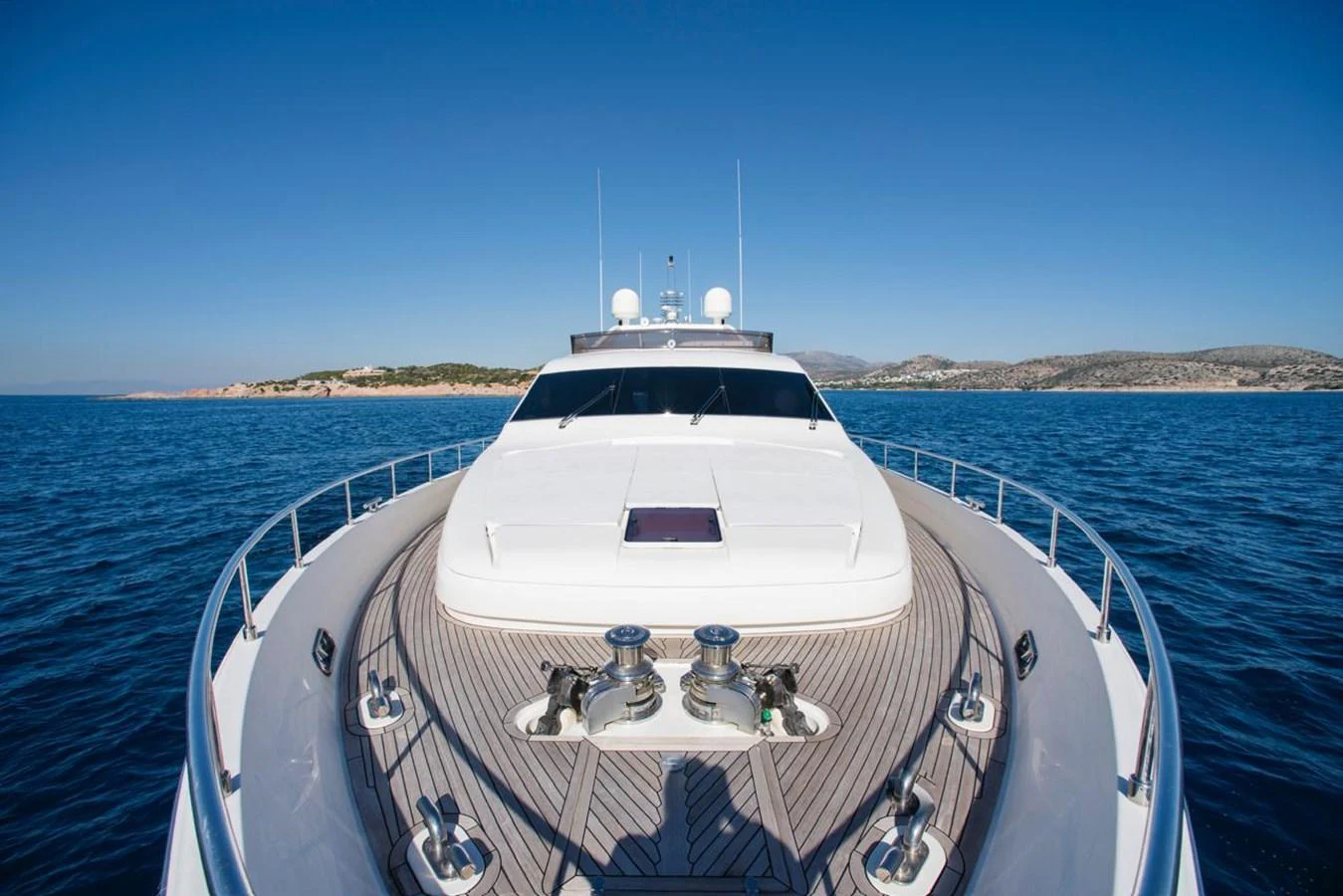 The yacht's sleek foredeck offers a stunning view of the open sea and distant coastline. aboard FERRETTI 881 Yacht for Sale