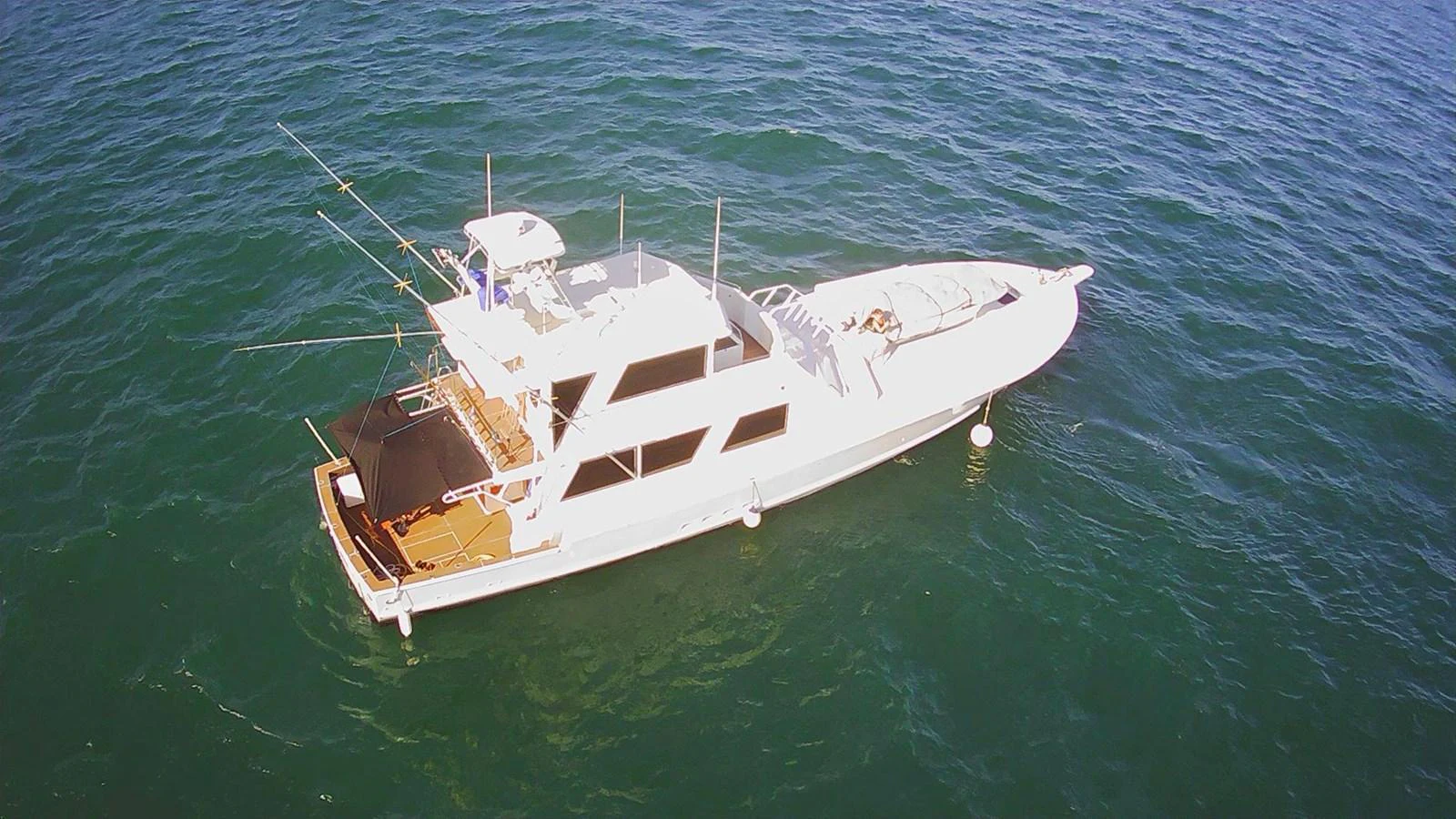 A sleek yacht cruises gracefully on the open water, showcasing its elegant design and spacious deck. aboard ADDISYN ANN Yacht for Sale