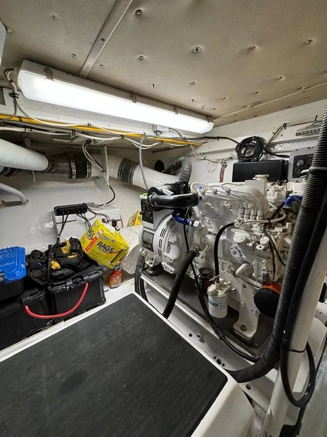 The image showcases the yacht's well-maintained engine room with various mechanical components and tools. aboard ADDISYN ANN Yacht for Sale
