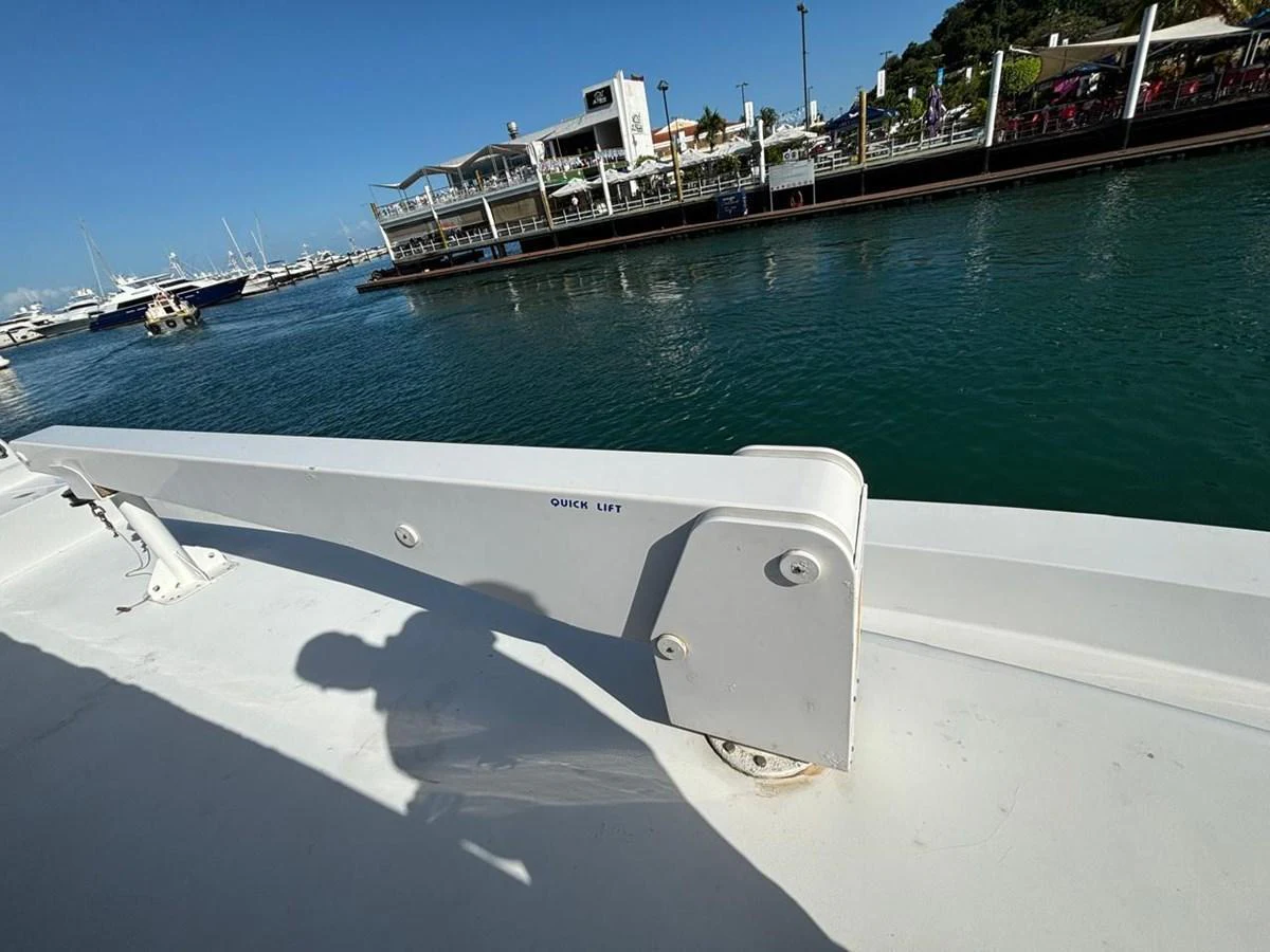 A close-up view of a yacht's davit system with a marina in the background. aboard ADDISYN ANN Yacht for Sale
