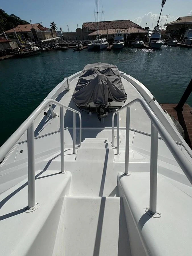 The yacht's bow area features a covered tender and a clean, spacious deck. aboard ADDISYN ANN Yacht for Sale