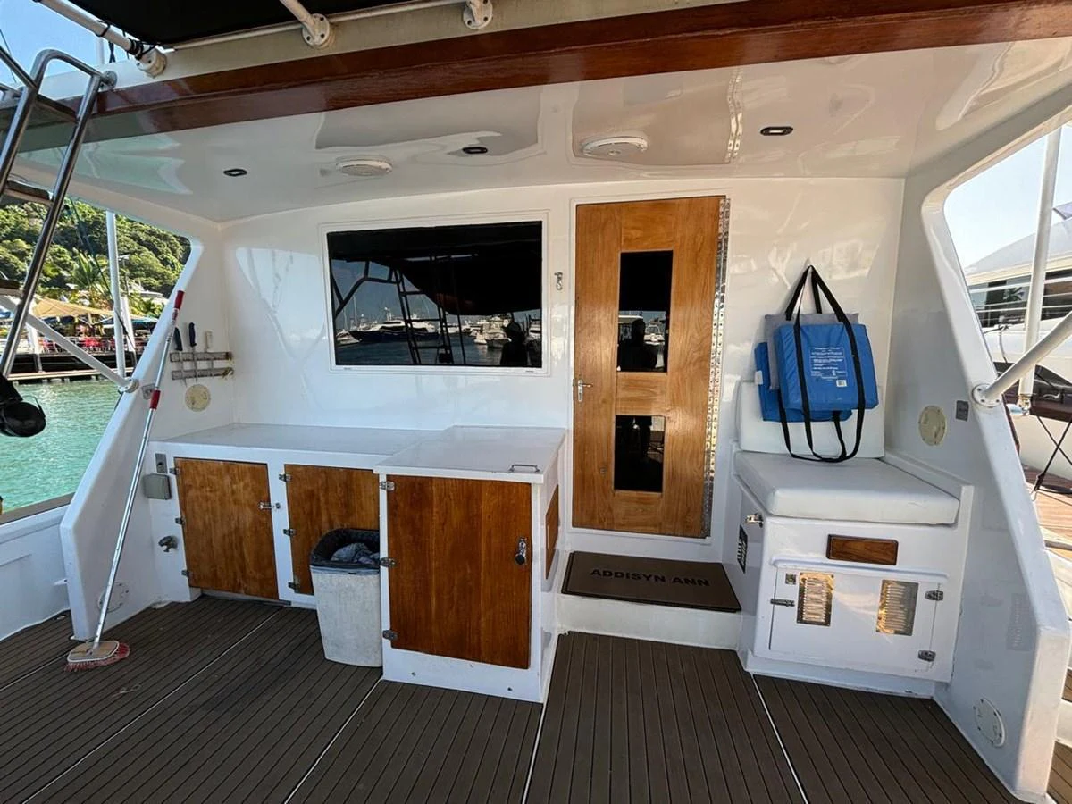 The aft deck features a clean and functional layout with wooden accents and practical storage solutions. aboard ADDISYN ANN Yacht for Sale