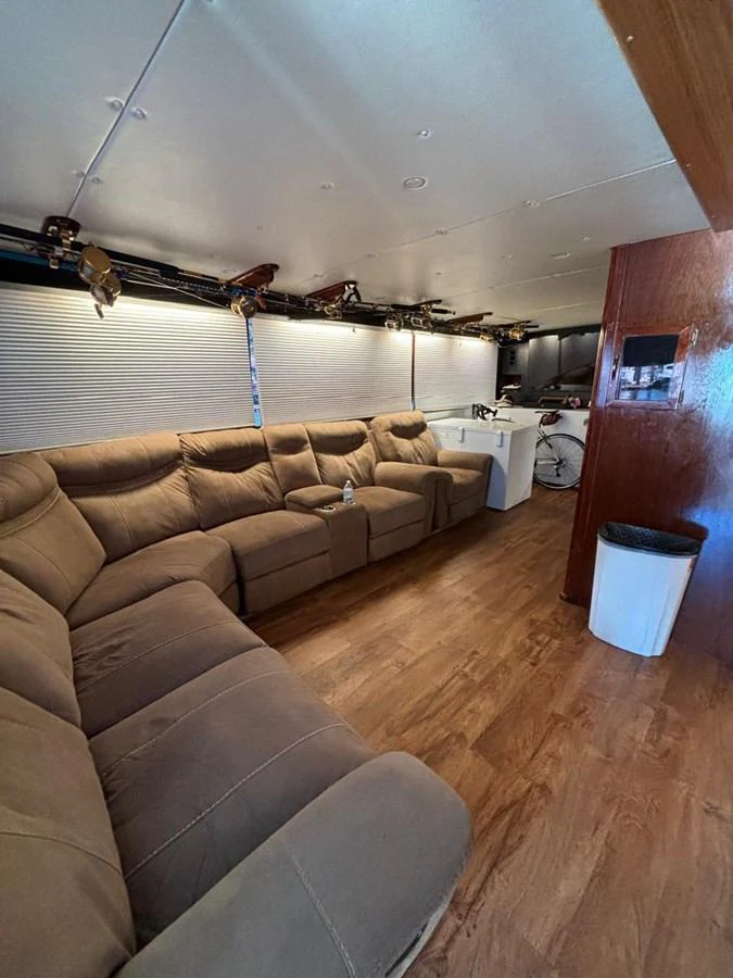 The interior features a cozy seating area with plush sofas and a well-lit ambiance. aboard ADDISYN ANN Yacht for Sale