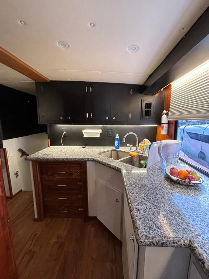 The galley features modern amenities with granite countertops and ample storage space. aboard ADDISYN ANN Yacht for Sale