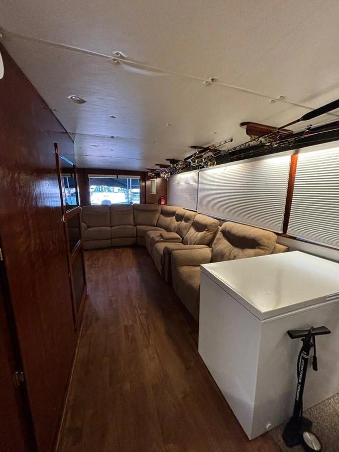 The salon features a comfortable L-shaped sofa and ample storage space, creating a cozy and functional living area. aboard ADDISYN ANN Yacht for Sale