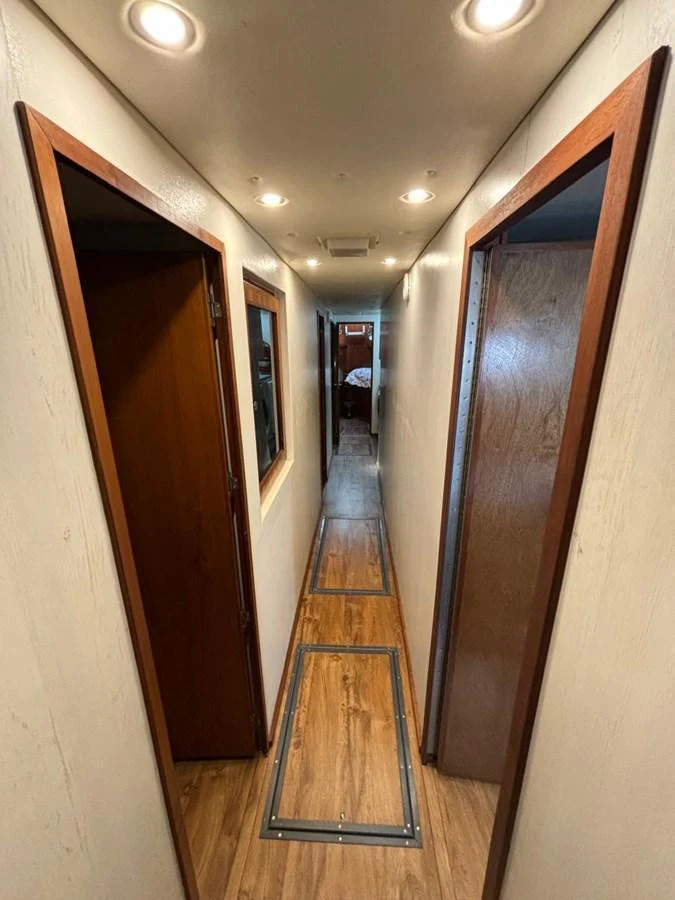 A sleek and well-lit hallway with wooden accents leads to the yacht's various rooms. aboard ADDISYN ANN Yacht for Sale