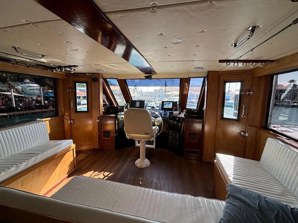 The helm area features comfortable seating and a panoramic view of the marina. aboard ADDISYN ANN Yacht for Sale