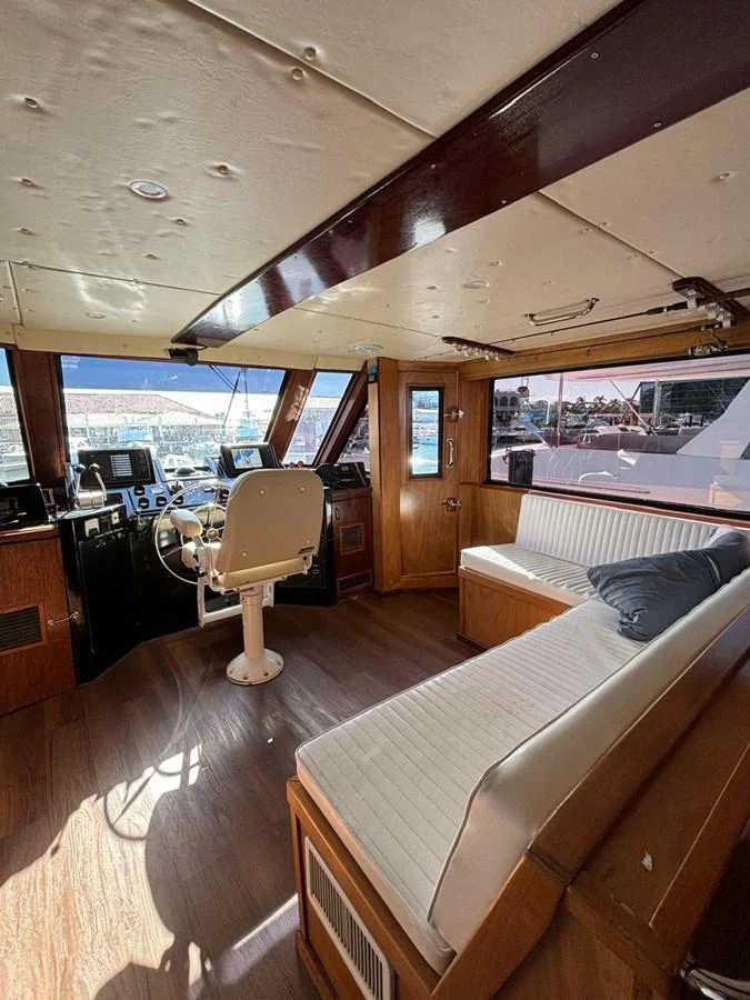 The helm area features a comfortable seating arrangement and modern navigation equipment. aboard ADDISYN ANN Yacht for Sale