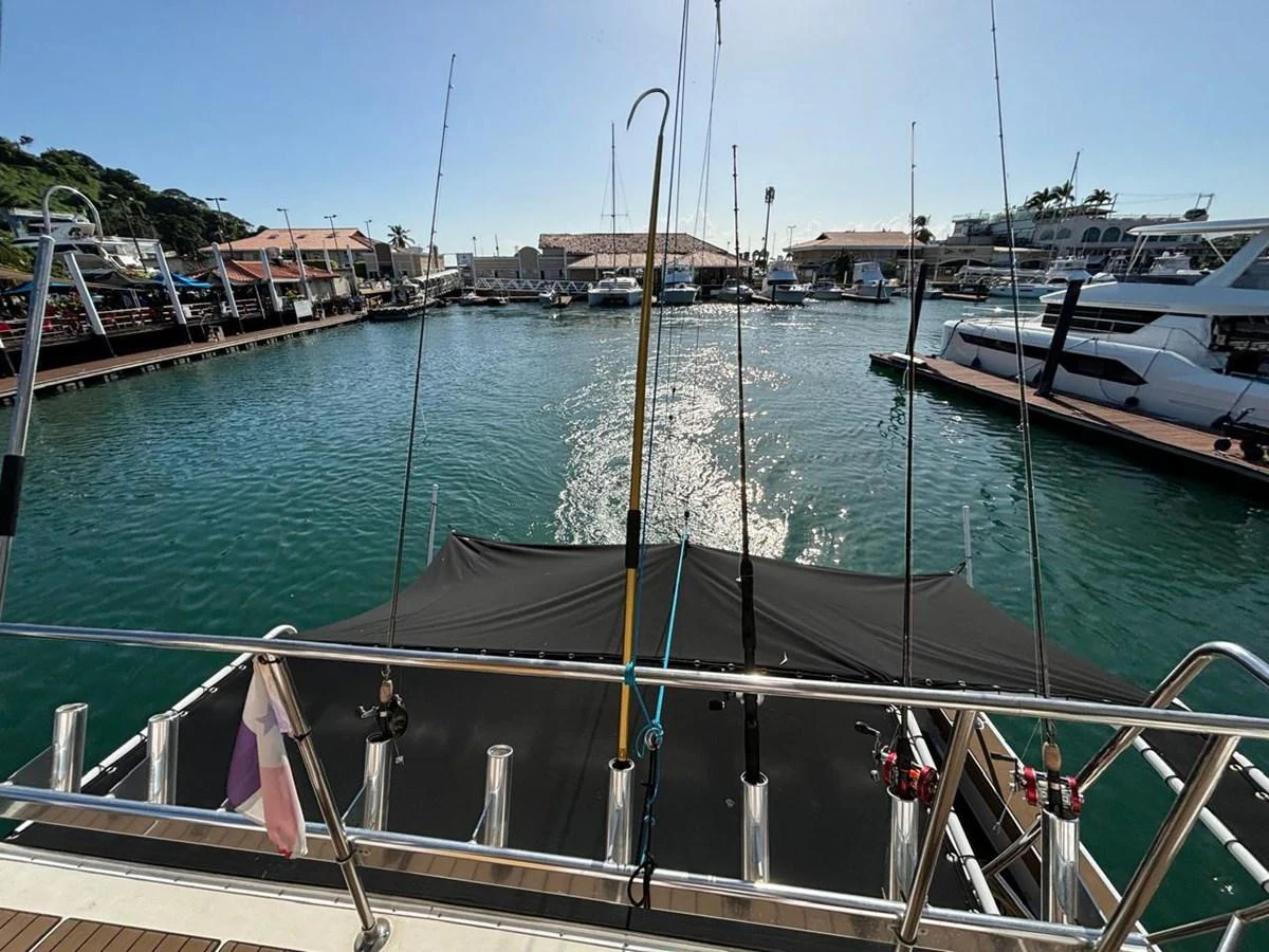 The aft deck of the yacht features fishing rods and a view of the marina. aboard ADDISYN ANN Yacht for Sale