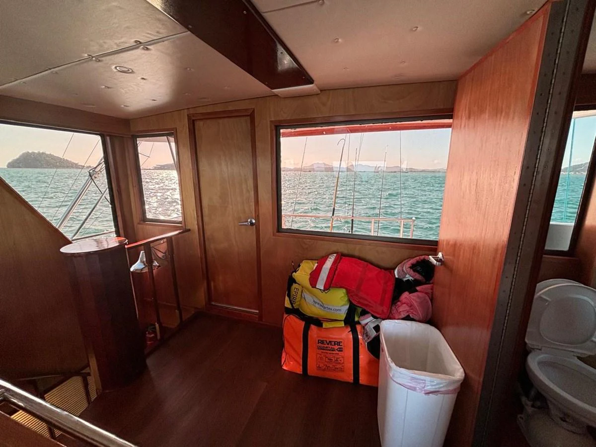 A cozy interior space with a view of the sea through large windows. aboard ADDISYN ANN Yacht for Sale