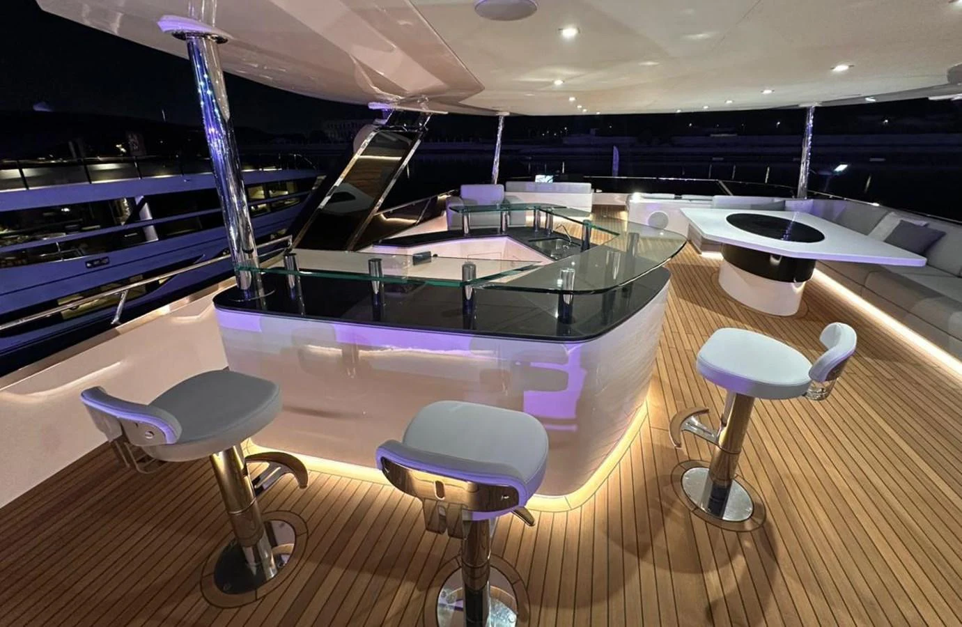 a room with tables and chairs aboard XCEL 70 Yacht for Sale