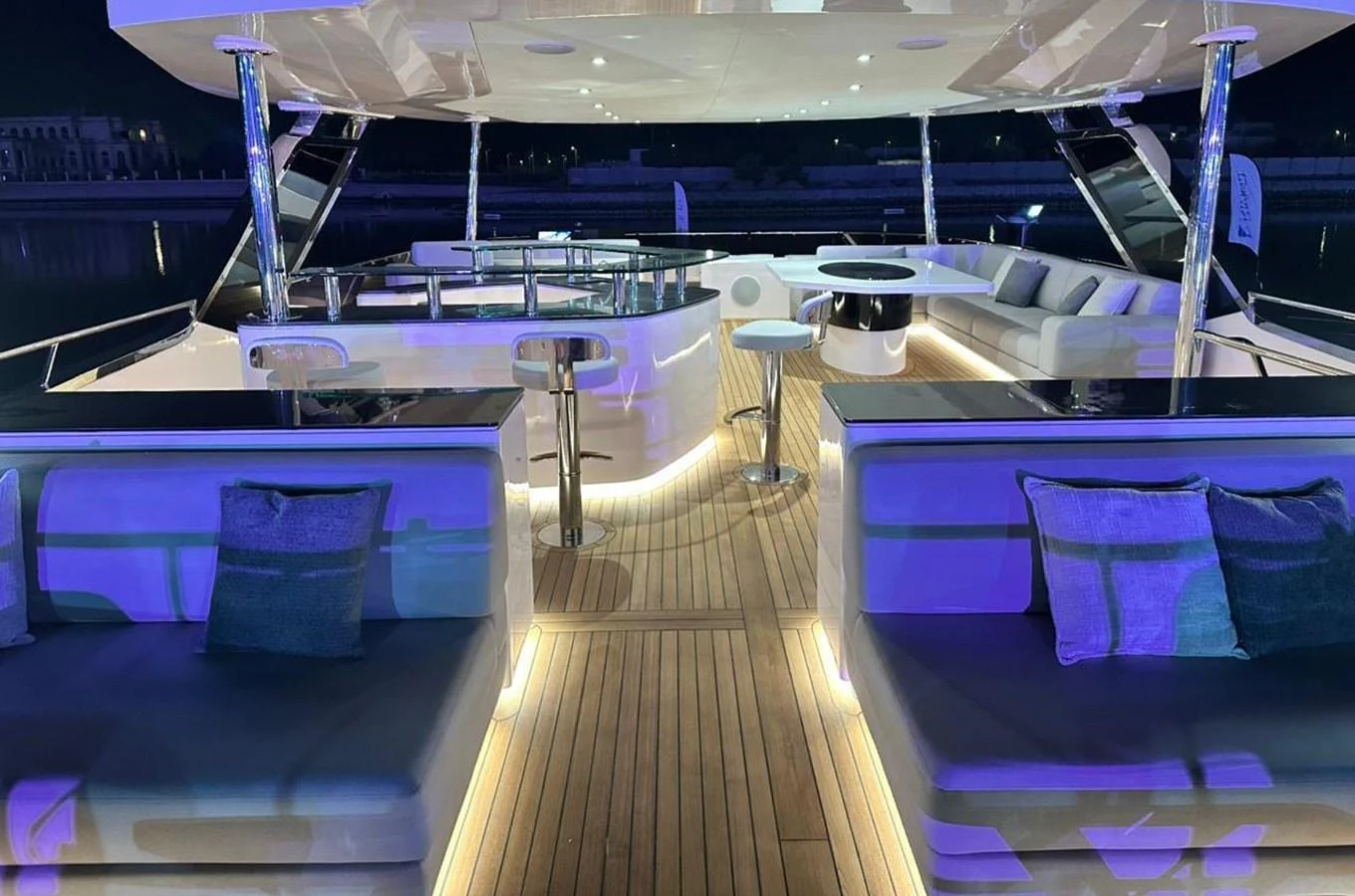 a boat with a deck and chairs aboard XCEL 70 Yacht for Sale