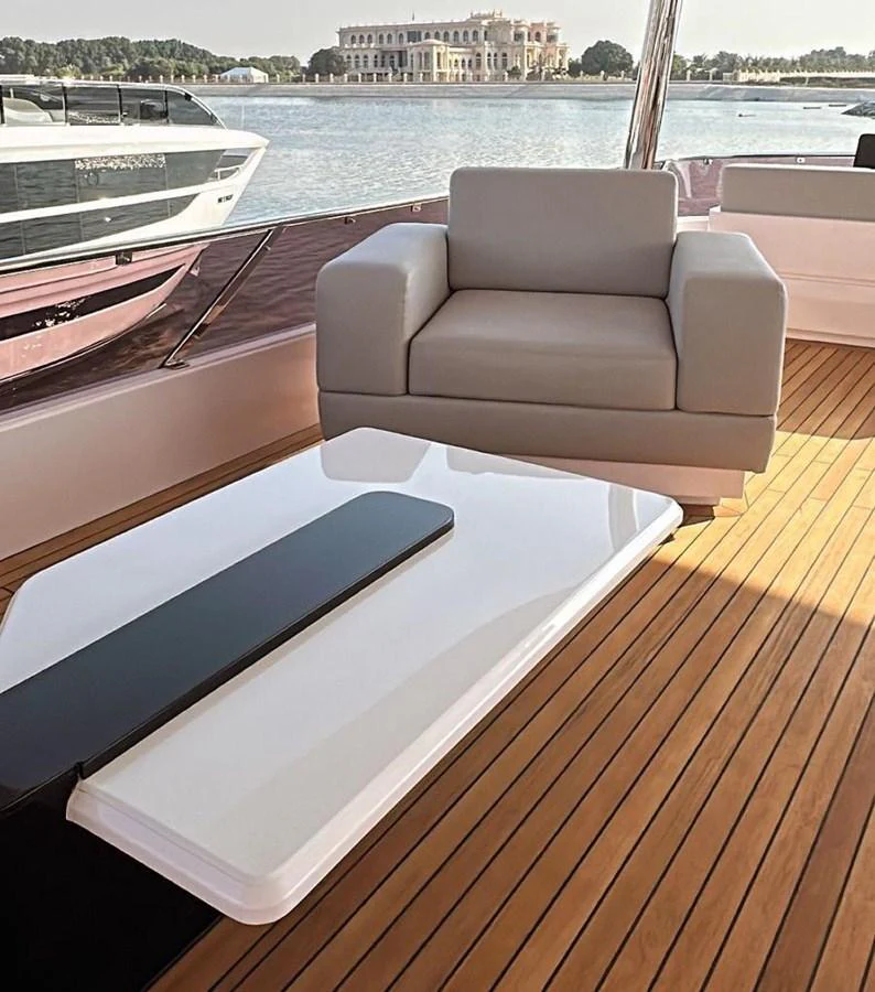 a chair on a deck overlooking a body of water aboard XCEL 70 Yacht for Sale