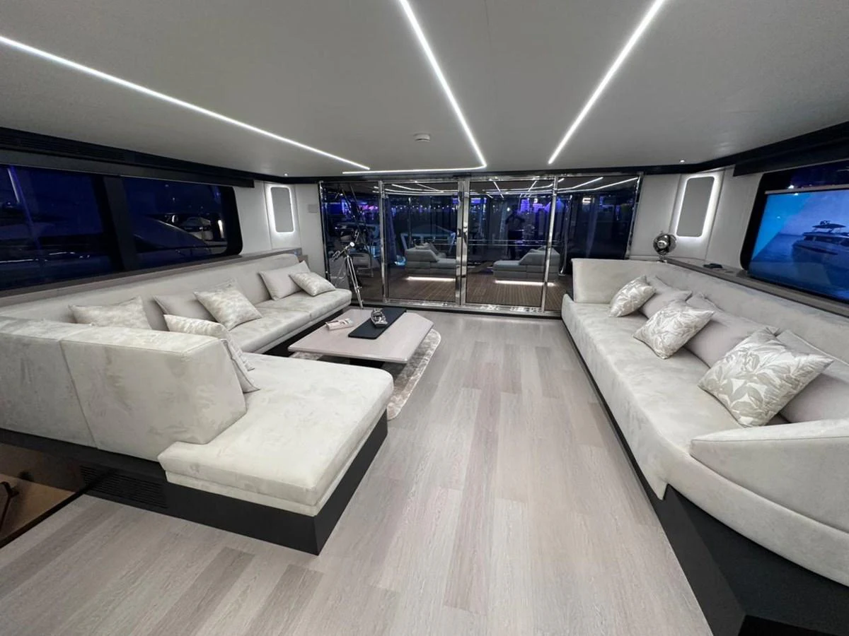 a living room with a large window aboard XCEL 70 Yacht for Sale