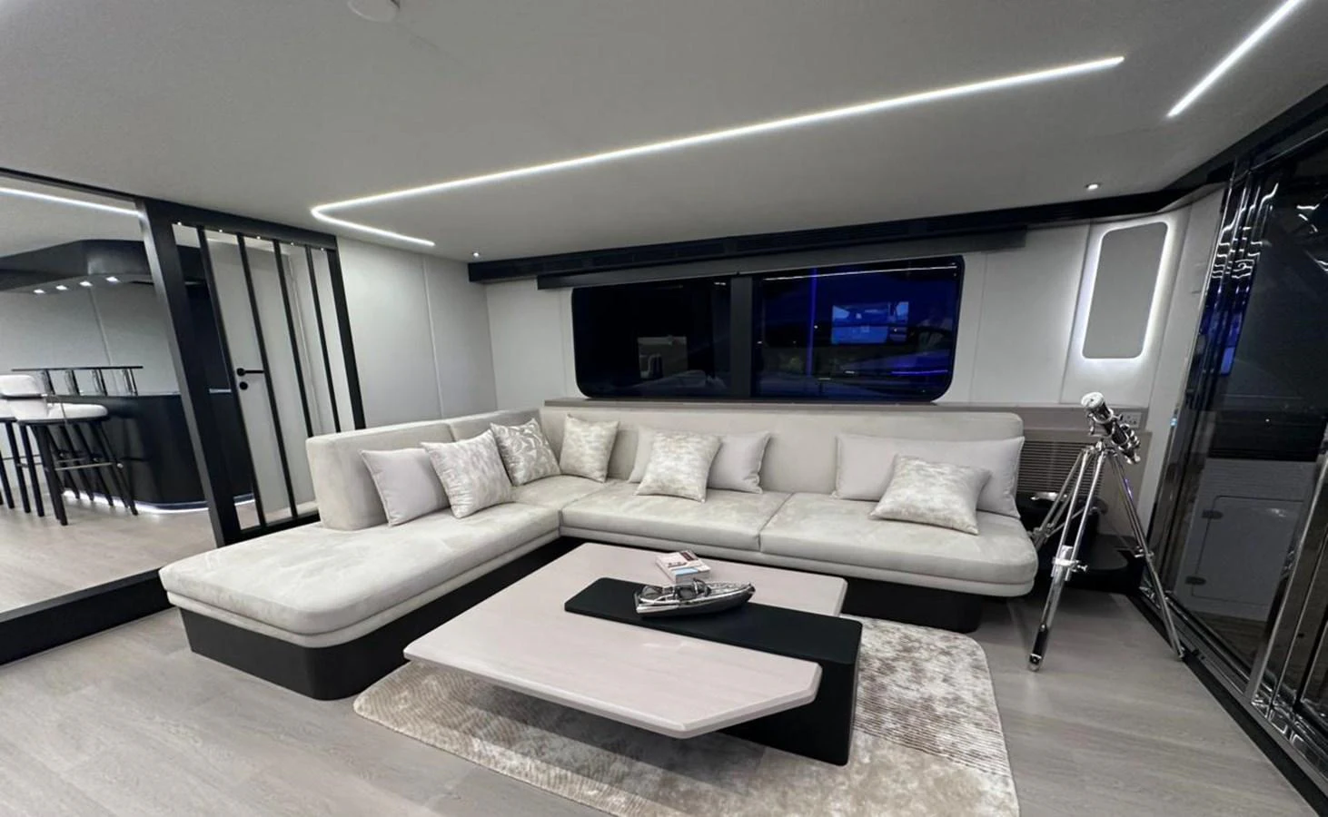 a living room with a large screen aboard XCEL 70 Yacht for Sale