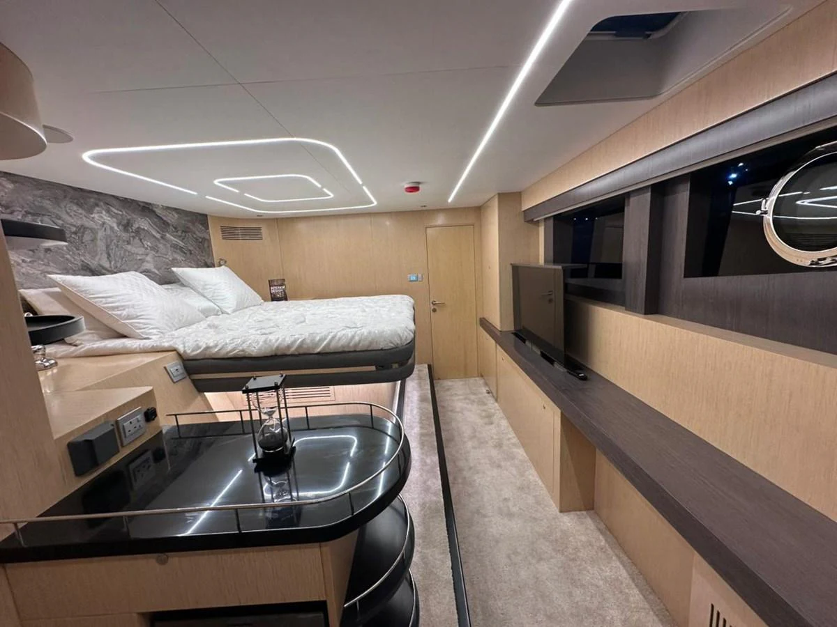 a room with a bed and a table aboard XCEL 70 Yacht for Sale