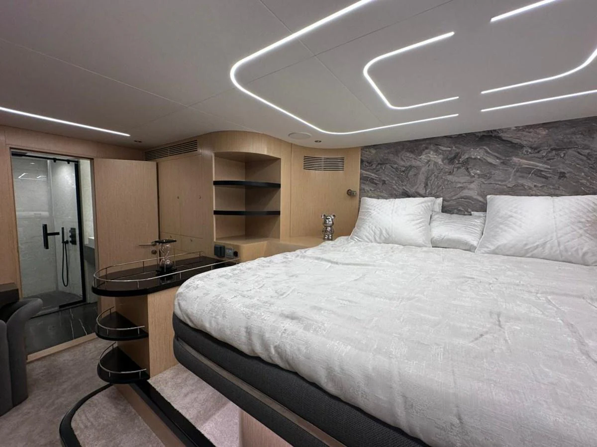 a bedroom with a bed and a desk aboard XCEL 70 Yacht for Sale