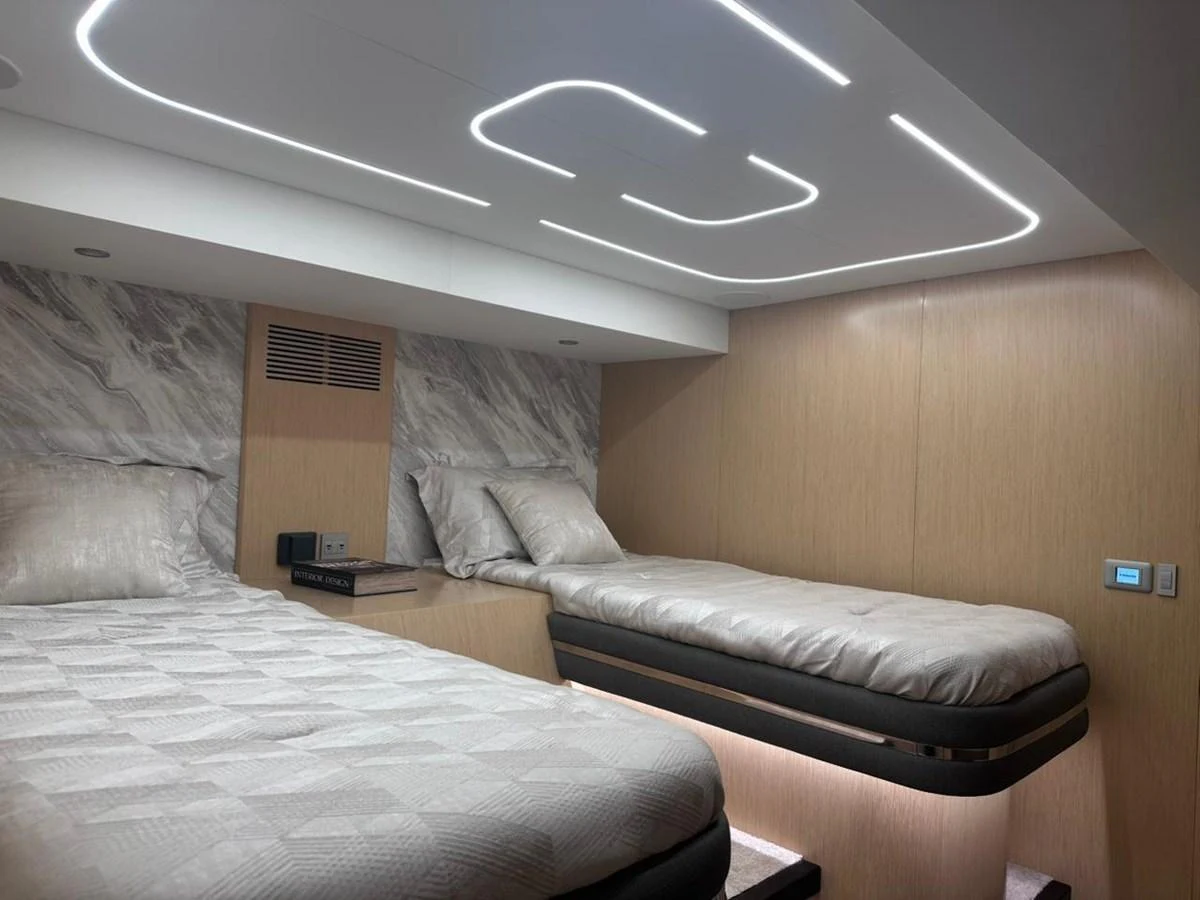a bed with a couch aboard XCEL 70 Yacht for Sale